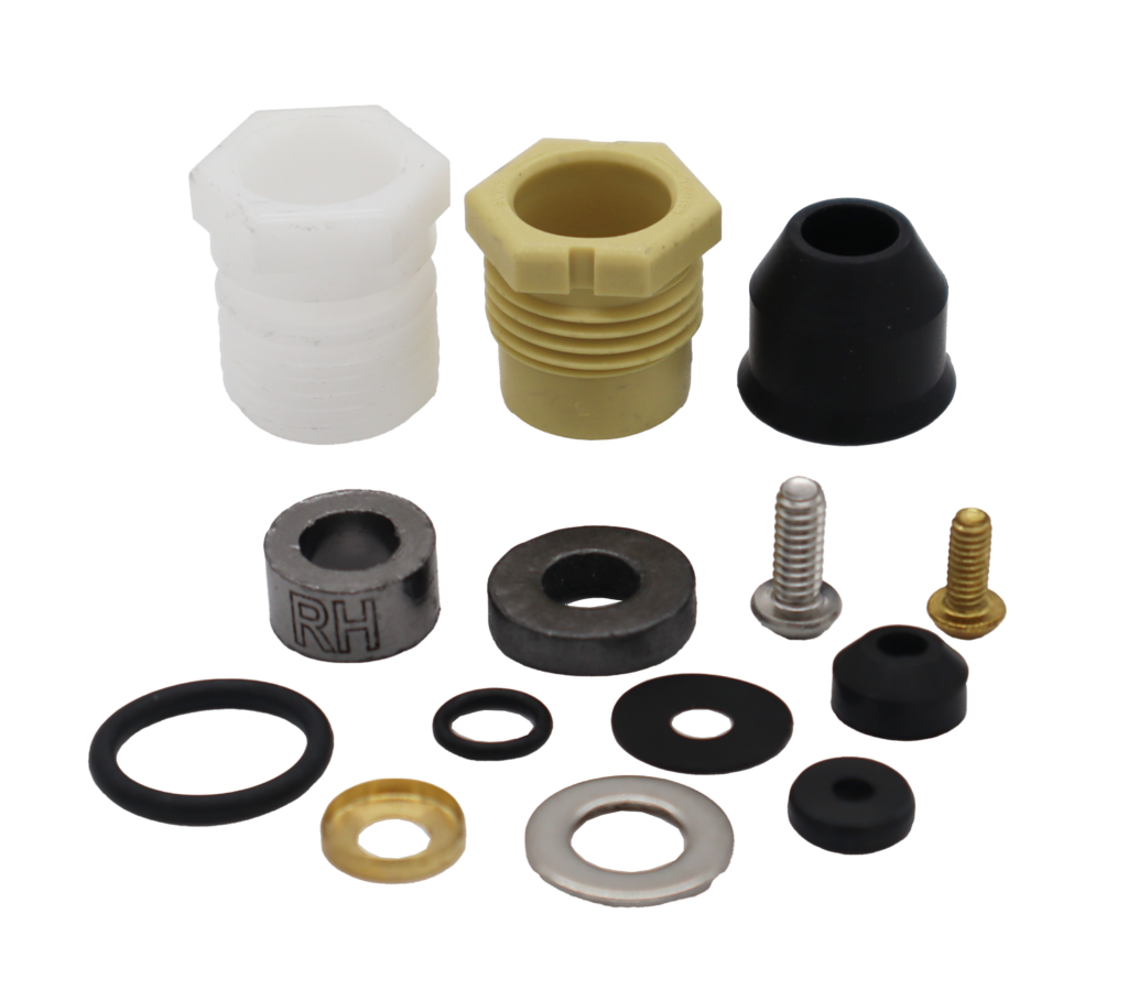 White and tand plastic bonnet nuts black rubber seals washers o-rings round grey graphite packings stainless screw and washer with bright brass retainer cup and brass screw.