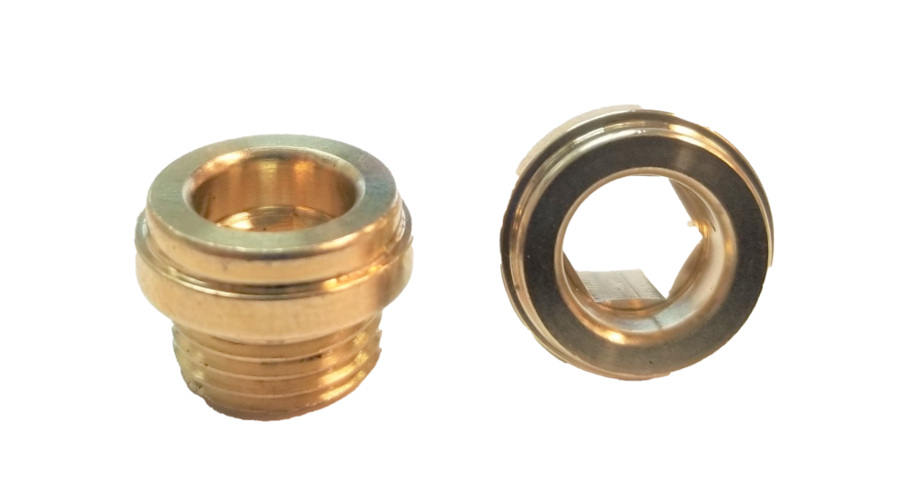 Bright brass faucet seats with threads on the bottom.