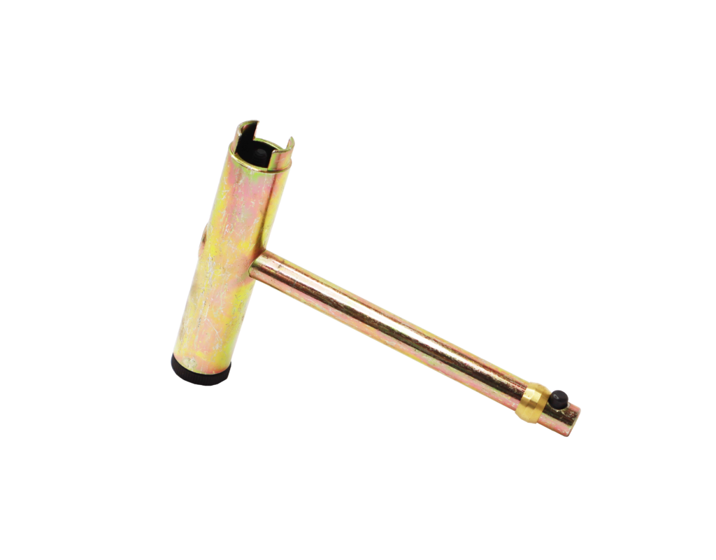Bright metal t shaped tool with brass ring.