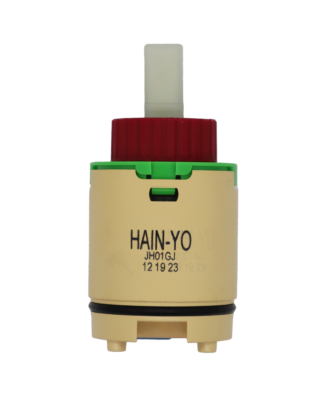 Tan plastic cartridge with green top red limit stop white square handle connection with black rubber o-ring blue rubber seal.