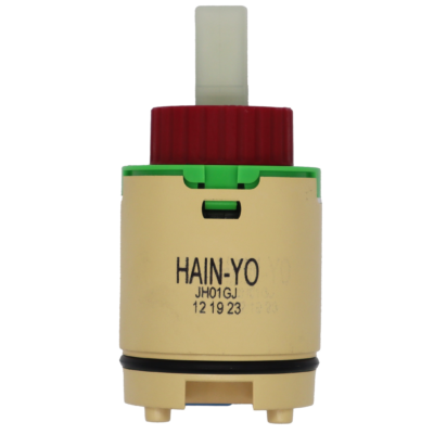 Tan plastic cartridge with green top red limit stop white square handle connection with black rubber o-ring blue rubber seal.