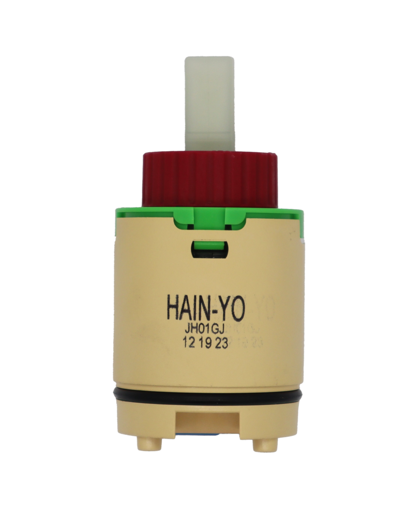 Tan plastic cartridge with green top red limit stop white square handle connection with black rubber o-ring blue rubber seal.