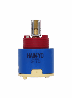 Bright blue plastic cartridge with red limit stop brass and metal handle connection tan bottom with blue seal.