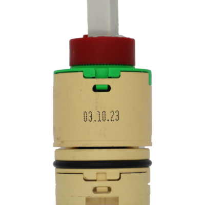 Tan plastic cartridge with green top with red limit stop with white square handle connection tan bottom balance with black o-ring and blue bottom seal.
