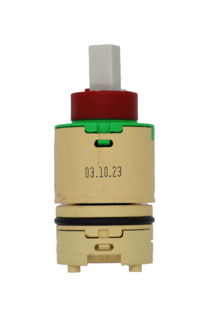 Tan plastic cartridge with green top with red limit stop with white square handle connection tan bottom balance with black o-ring and blue bottom seal.