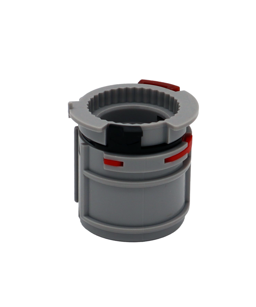 Grey plastic control adapter with red plastic tabs.