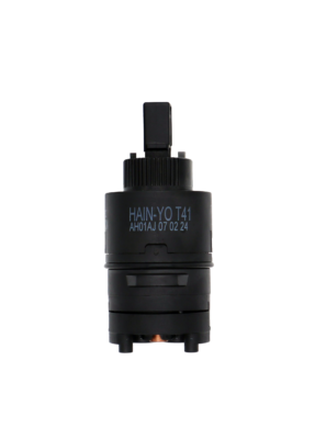 Black thermostatic cartridge with square handle connection and copper temp balance on the bottom.